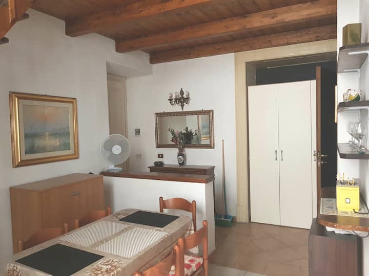 Downstairs: table with chairs, second wardrobe, toaster,bathroom door on the right.